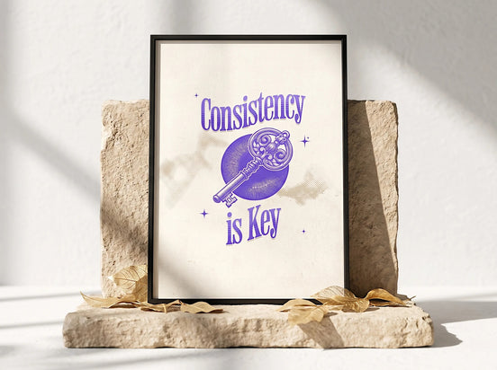 Essences Agape affiche "Consistency is Key" avec une clé ornementale violette sur fond crème, art mural spirituel inspirant.