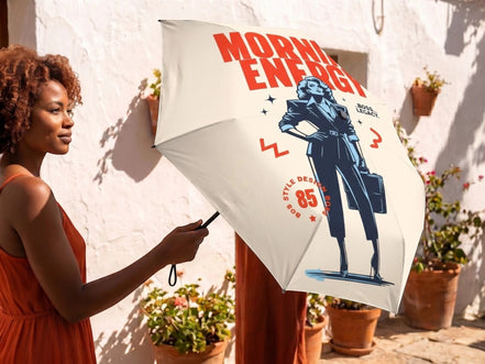 Parapluie pliant Essences Agape, style vintage, avec illustration d'une femme d'affaires et texte 'Morning Energy'.