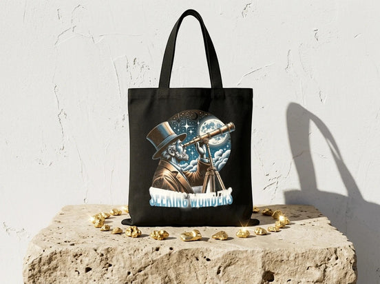 Sac cabas noir Essences Agape en toile de coton avec illustration d'un homme au chapeau haut-de-forme regardant les étoiles avec un télescope.
